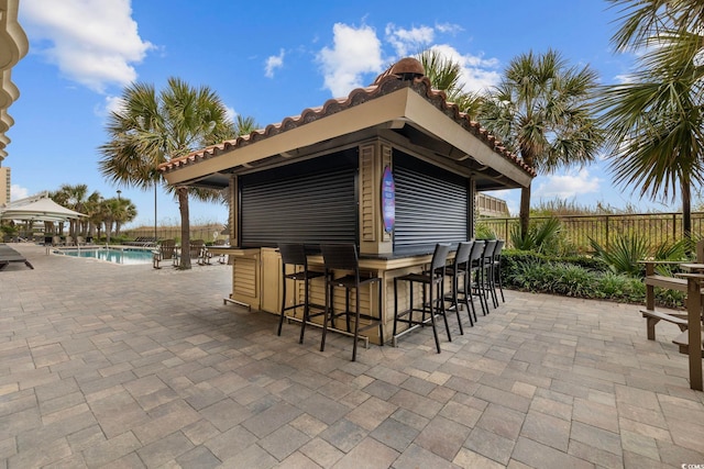 603 S Ocean Blvd Unit 1115, North Myrtle Beach, SC 29582 - view of patio with fence, a community pool, and a gazebo