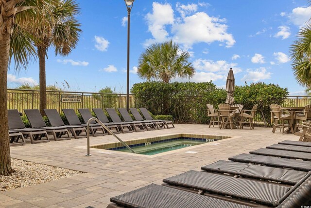 603 S Ocean Blvd Unit 1115, North Myrtle Beach, SC 29582 - view of swimming pool featuring a community hot tub, a patio area, fence, and outdoor dining area