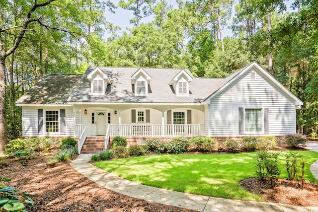 new england style home with a porch and a front yard