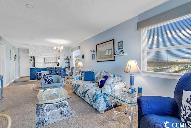 carpeted living room featuring an inviting chandelier and a wealth of natural light