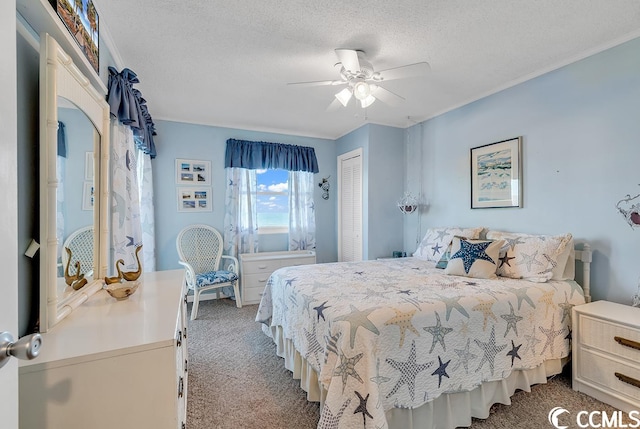 carpeted bedroom with a textured ceiling, a closet, and ceiling fan