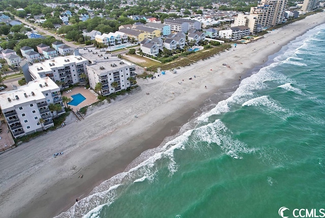 bird's eye view featuring a water view and a beach view