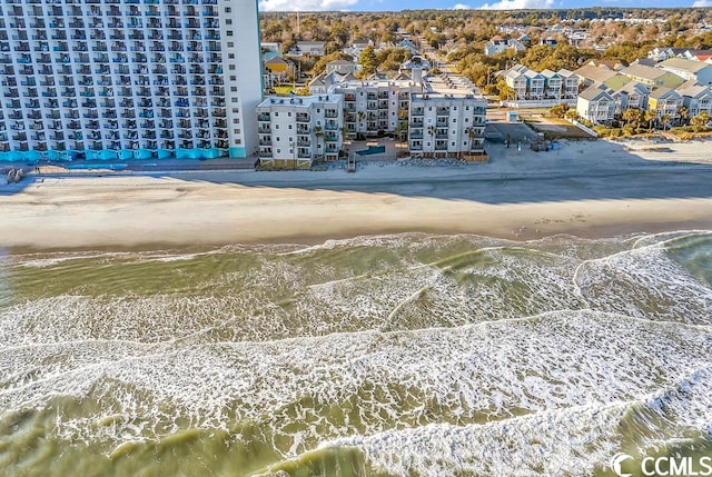 birds eye view of property featuring a water view and a beach view