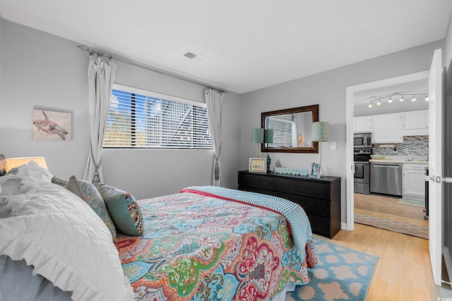 bedroom with light hardwood / wood-style floors