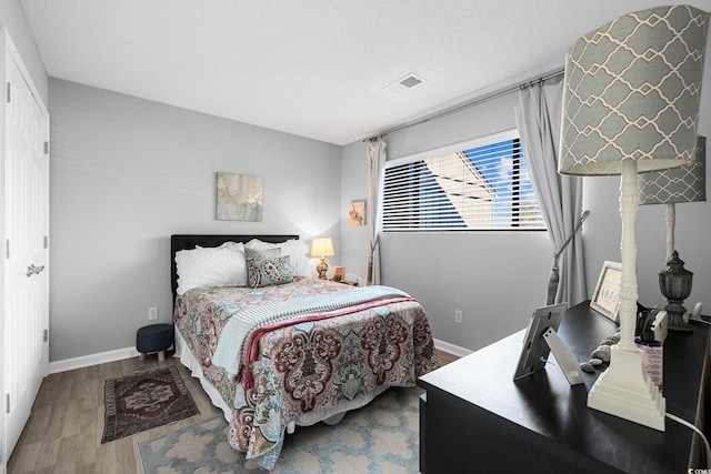 bedroom with dark hardwood / wood-style floors