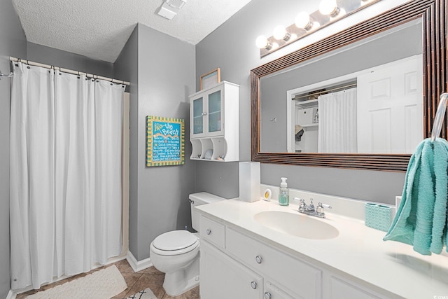 bathroom with toilet, a textured ceiling, tile floors, and large vanity