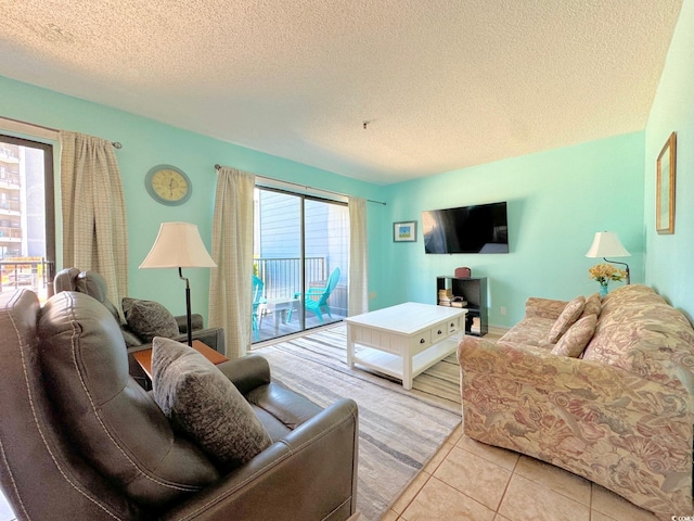 living room with light tile flooring and a textured ceiling