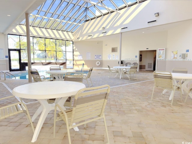 view of patio with glass enclosure