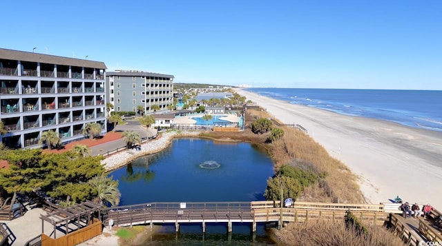 bird's eye view with a water view and a beach view