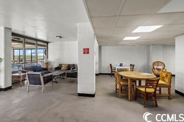 dining space with a drop ceiling