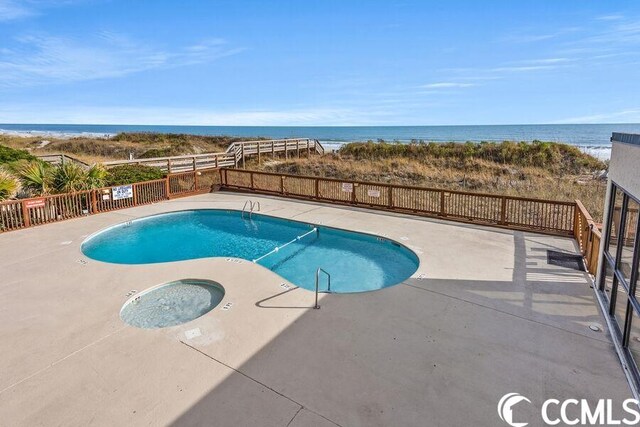 view of swimming pool with a water view and a community hot tub