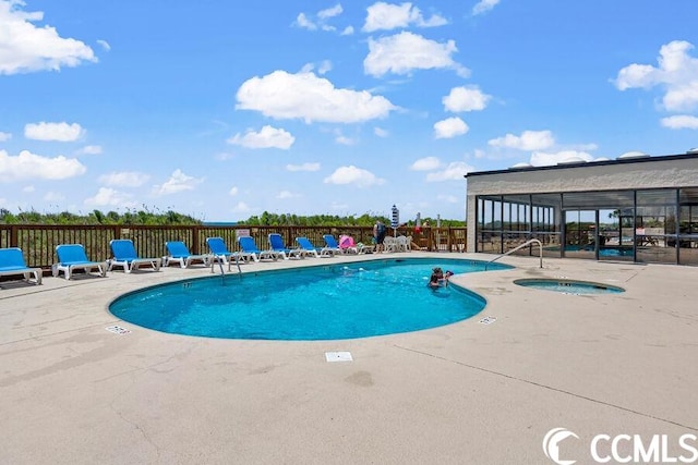 view of swimming pool featuring a patio and a community hot tub