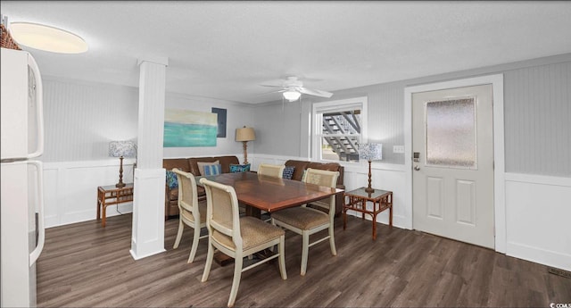 dining room with dark hardwood / wood-style flooring, a textured ceiling, and ceiling fan