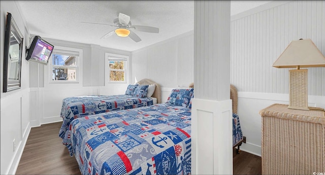 bedroom featuring ceiling fan, wood-type flooring, and a textured ceiling