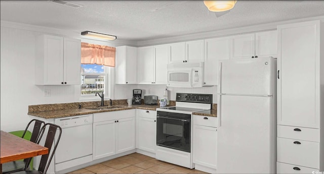 kitchen with sink, white appliances, a textured ceiling, and white cabinets