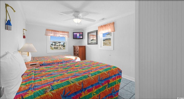 bedroom with ceiling fan and light tile patterned flooring