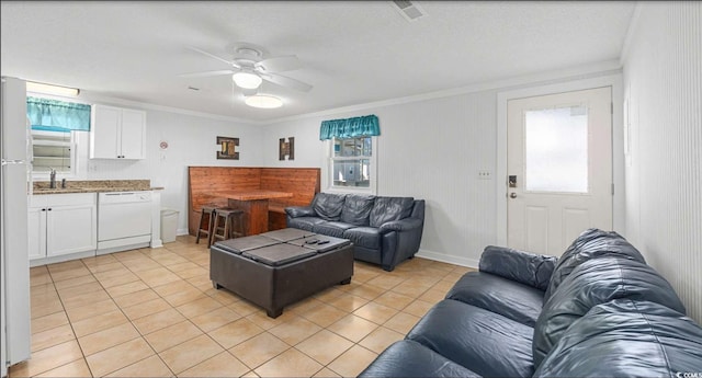 tiled living room with crown molding, plenty of natural light, sink, and ceiling fan