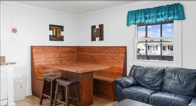 interior space with ornamental molding and indoor bar