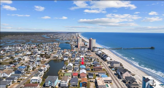 bird's eye view with a water view and a beach view