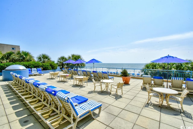 view of terrace with a water view