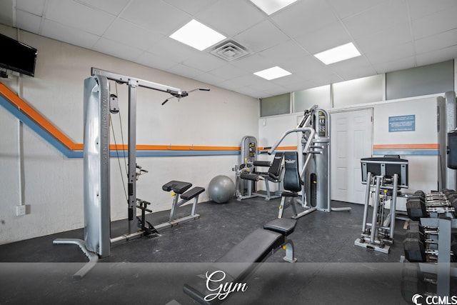 gym with a paneled ceiling