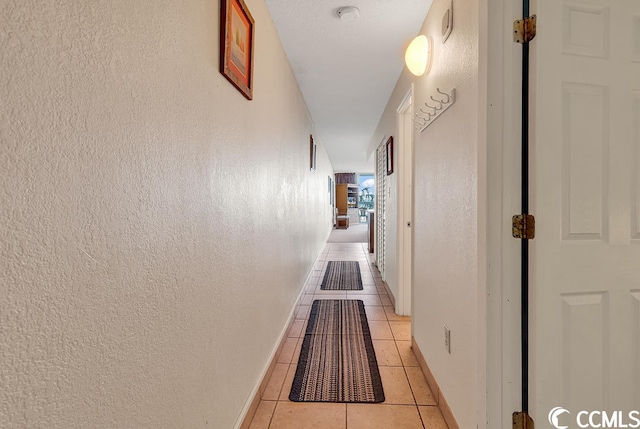 corridor featuring light tile floors