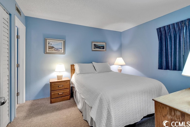 carpeted bedroom with a textured ceiling