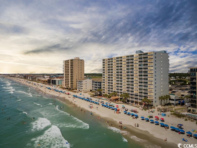 exterior space with a water view and a beach view