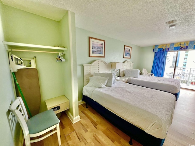 1207 S Ocean Blvd Unit 50804, Myrtle Beach, SC 29577 - bedroom featuring wood finished floors and a textured ceiling