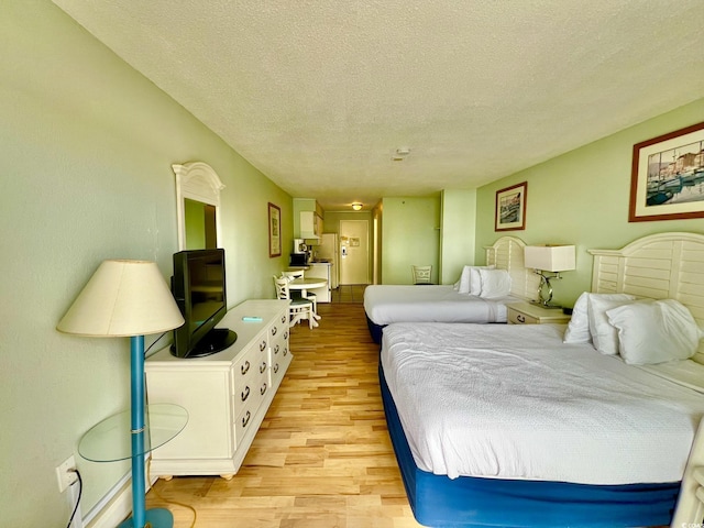 1207 S Ocean Blvd Unit 50804, Myrtle Beach, SC 29577 - bedroom with light wood-style flooring and a textured ceiling