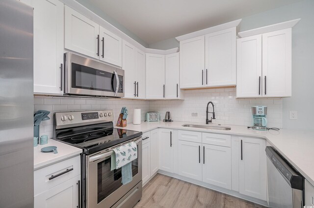 503 30th Ave N, Myrtle Beach, SC 29577 - kitchen with appliances with stainless steel finishes, a sink, light countertops, and backsplash