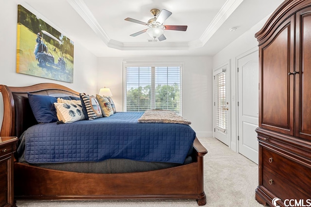 bedroom featuring ornamental molding, light carpet, ceiling fan, and a raised ceiling