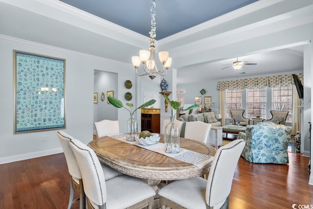 dining room with a raised ceiling, crown molding, ceiling fan with notable chandelier, and dark hardwood / wood-style flooring