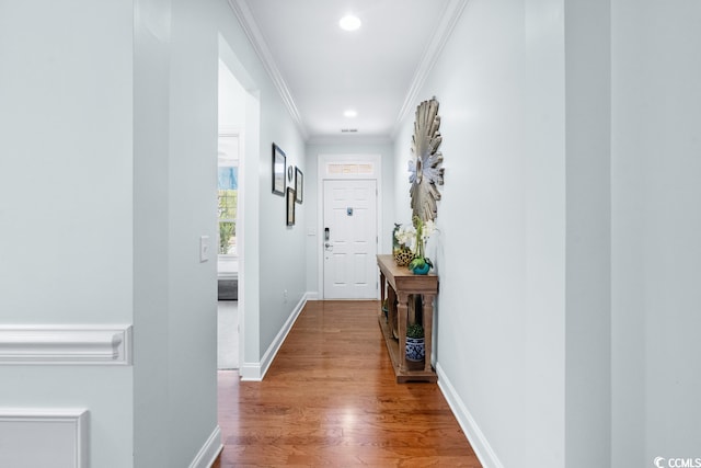 hall featuring ornamental molding and hardwood / wood-style flooring