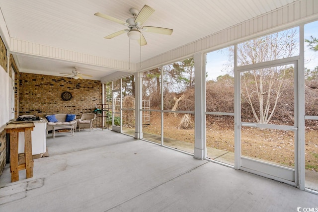 unfurnished sunroom with ceiling fan and a wealth of natural light