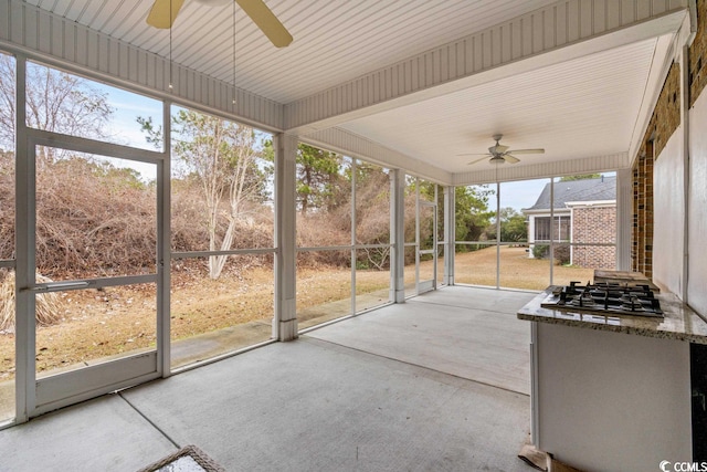 unfurnished sunroom with ceiling fan