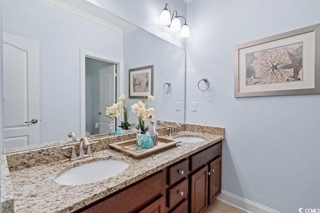 bathroom featuring double sink, ornamental molding, and large vanity