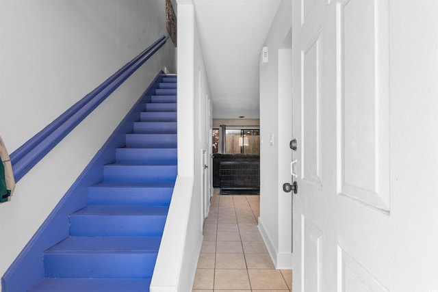 stairway featuring tile patterned flooring