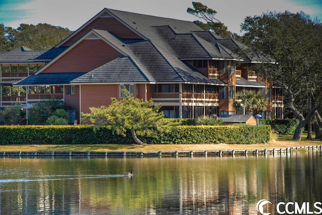 rear view of property featuring a water view