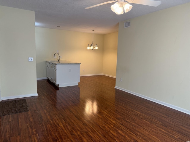 interior space with a sink, dark wood-style floors, visible vents, and ceiling fan with notable chandelier