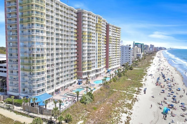 view of property with a water view and a view of the beach