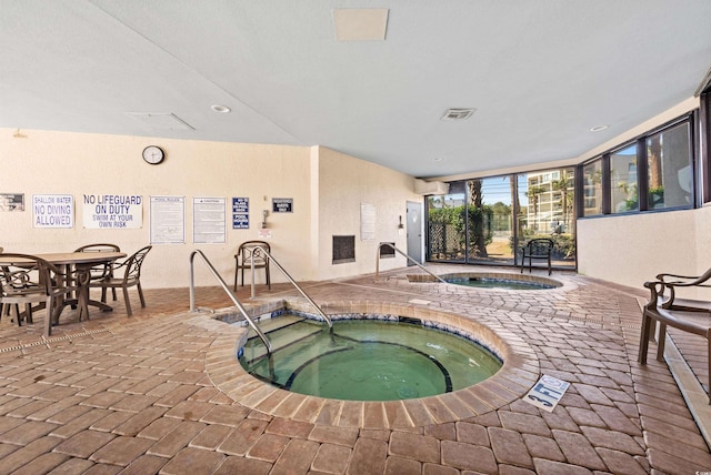 view of pool featuring an indoor hot tub