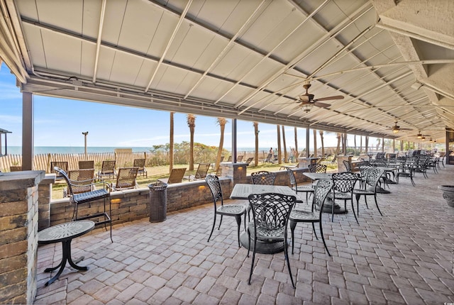 view of patio with ceiling fan and a water view