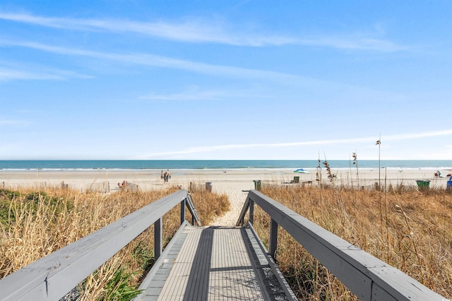 view of nearby features with a water view and a beach view