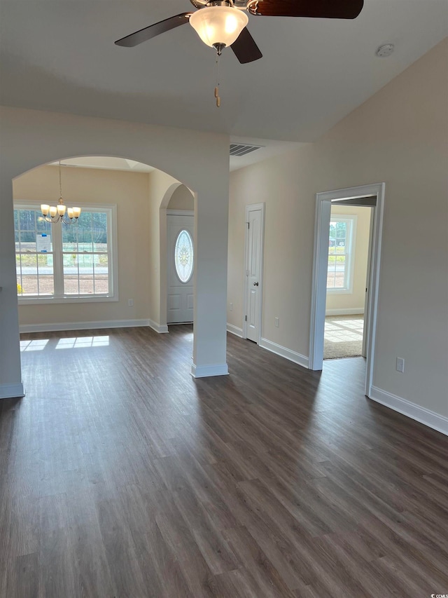 unfurnished living room with ceiling fan with notable chandelier and dark hardwood / wood-style floors