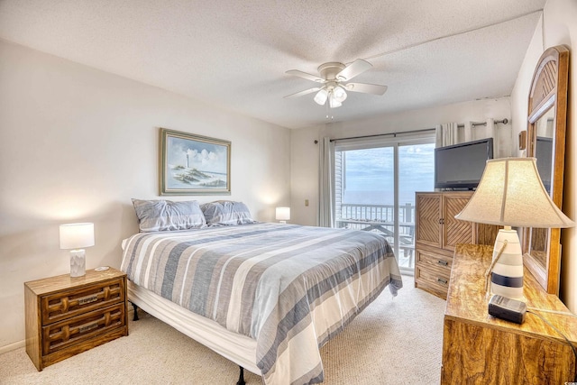 bedroom with light carpet, access to exterior, ceiling fan, and a textured ceiling