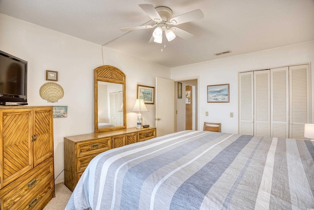 bedroom featuring a closet, ceiling fan, and light colored carpet