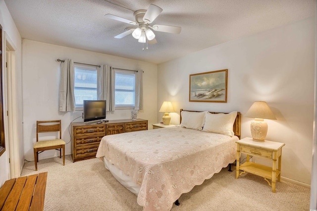 bedroom with light carpet, a textured ceiling, and ceiling fan