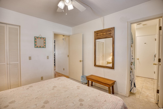 tiled bedroom featuring a closet and ceiling fan