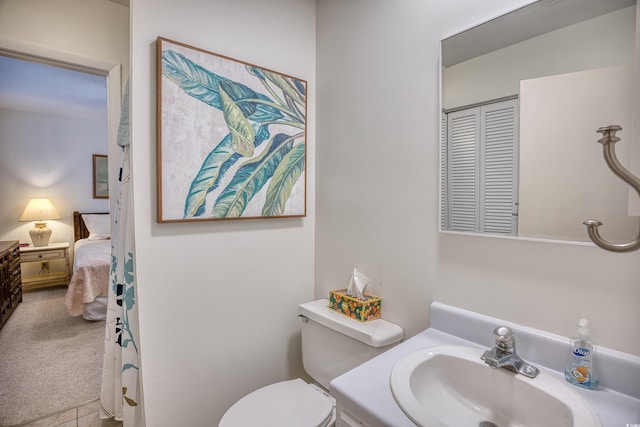 bathroom featuring sink and toilet